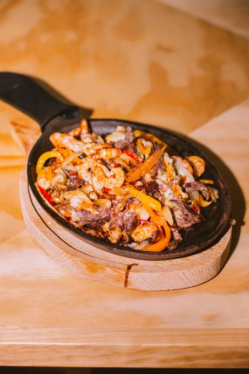 Sizzling chicken fajitas in a skillet